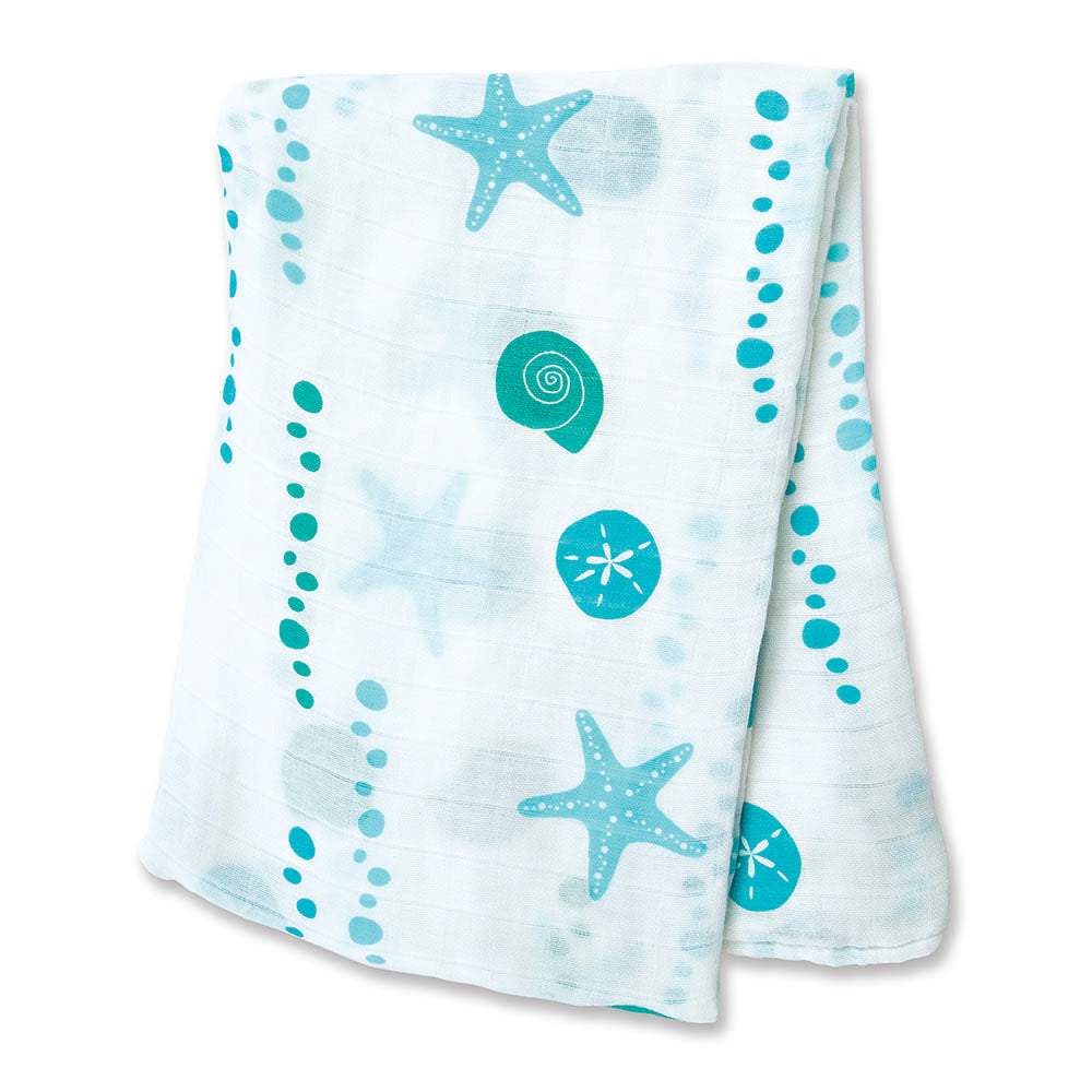 Mint green sea shells and starfish pattern on a white folded baby blanket