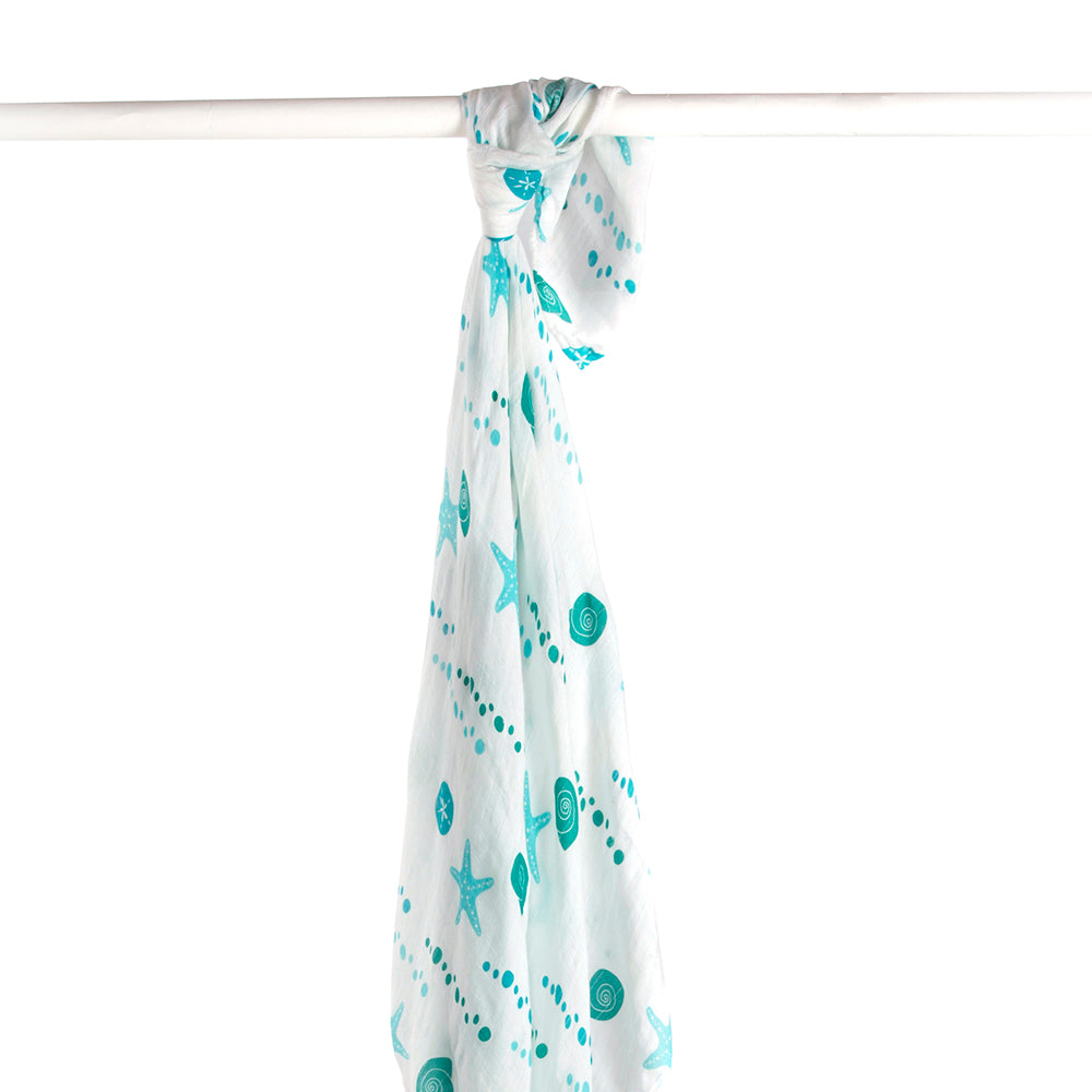 Turquoise sea shells and starfish ocean patterns on a white baby swaddle blanket