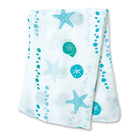 Mint green sea shells and starfish pattern  on a white folded baby blanket